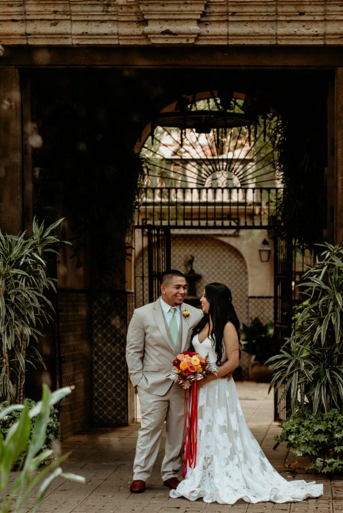 Wedding couple looking into each others eyes under one of the Tlaquepaque arches