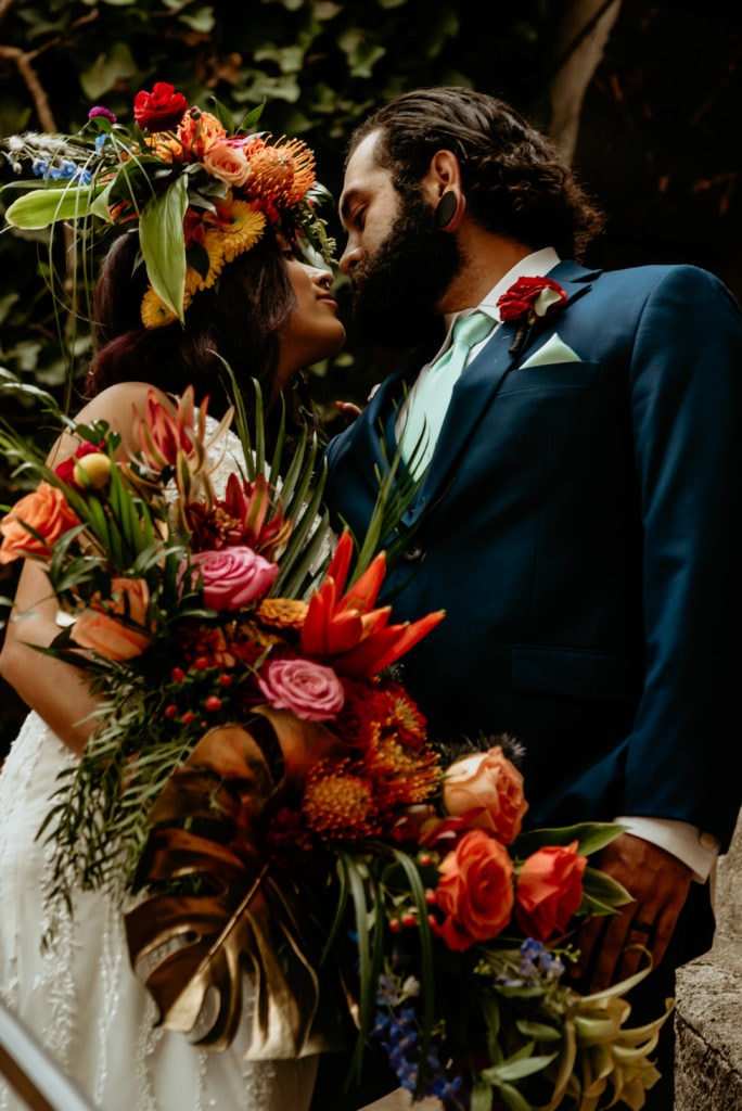 Bold and colorful tropical bouquet held by bride