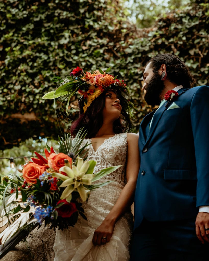 Bride and groom descending the stairs of a vined courtyard in Sedona, Arizona