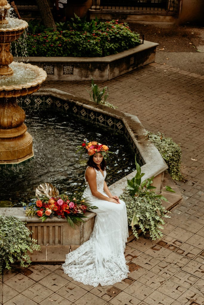 Tropical bride seated at deep blue fountain in Tlaquepaque