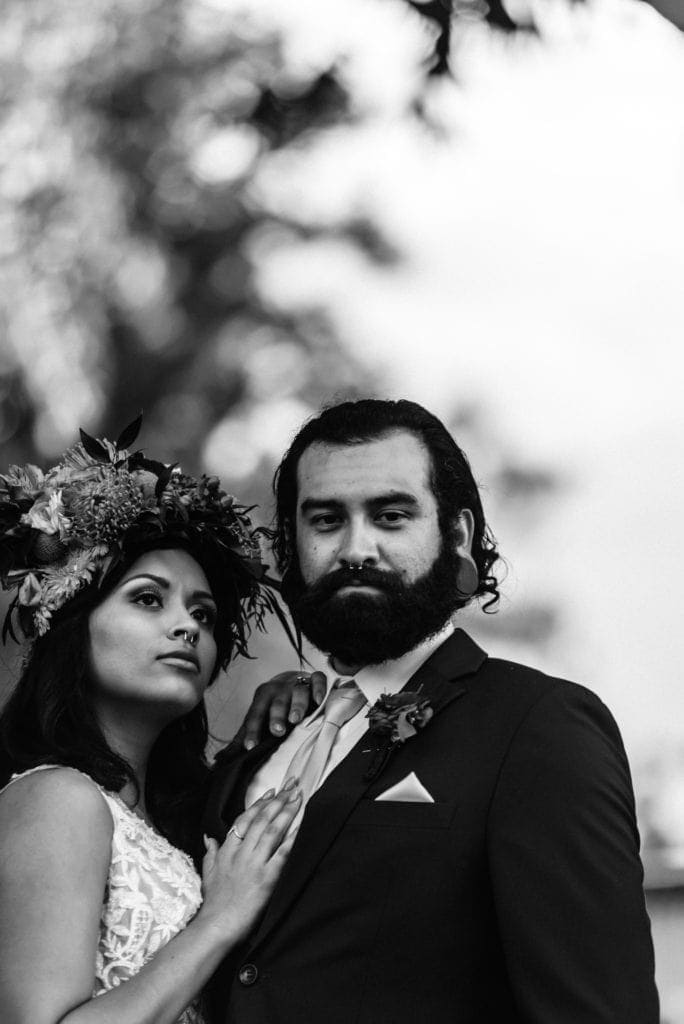 Black and white photo of groom staring into camer