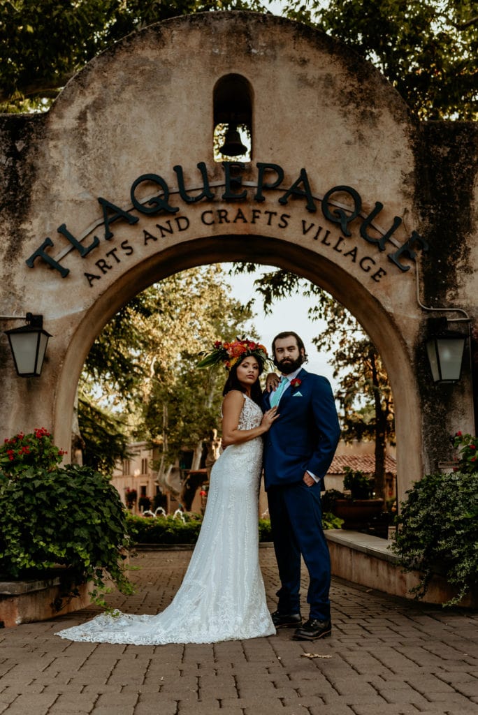 Bride and groom in front of the Tlaquepaque main entrance