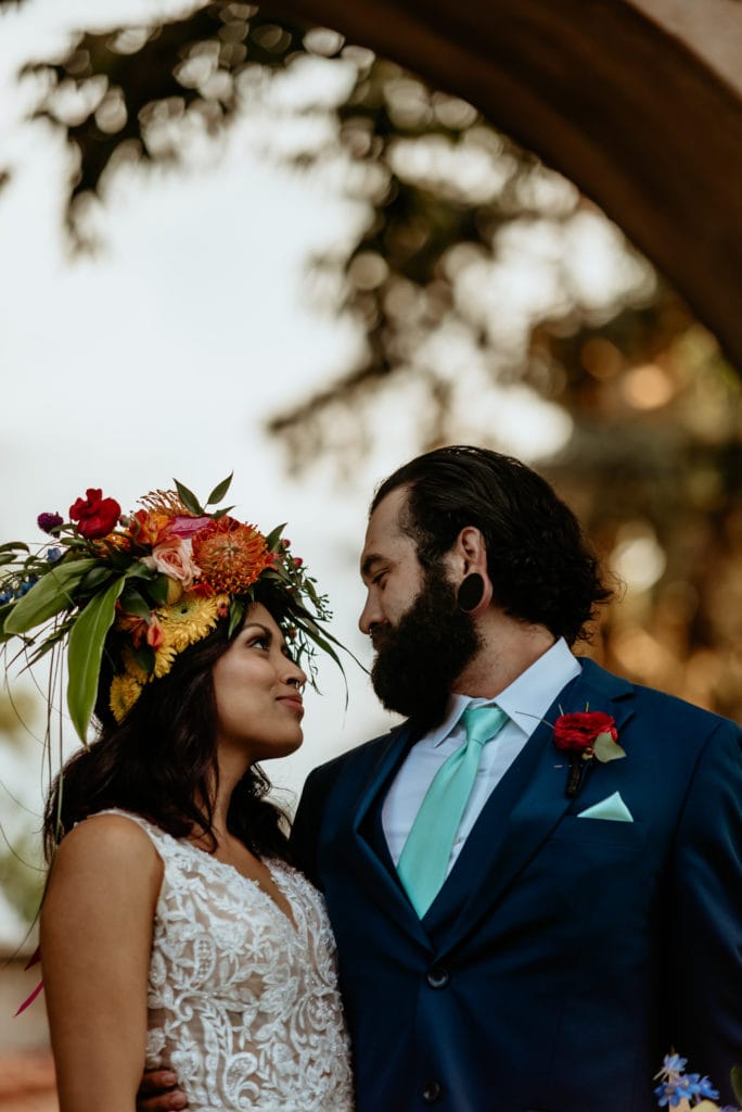 Bride and groom smile and look into each others eyes