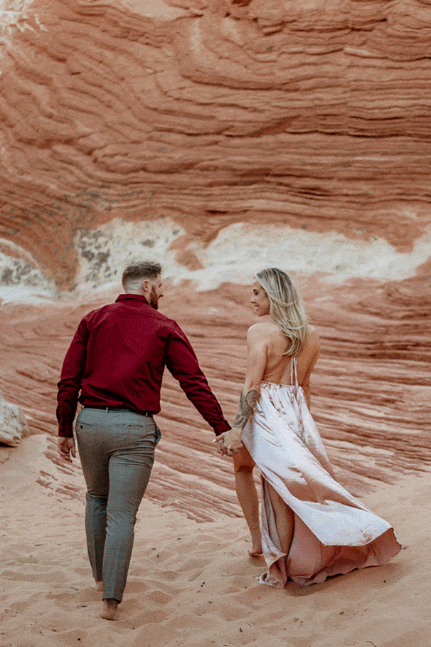 Couple walking through the sand at their Vermillion Cliffs Engagement Session