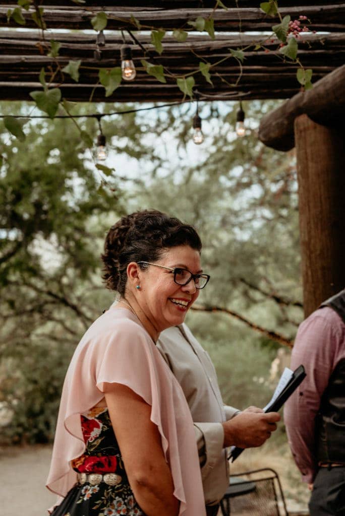 best friend and officiant joking with groom