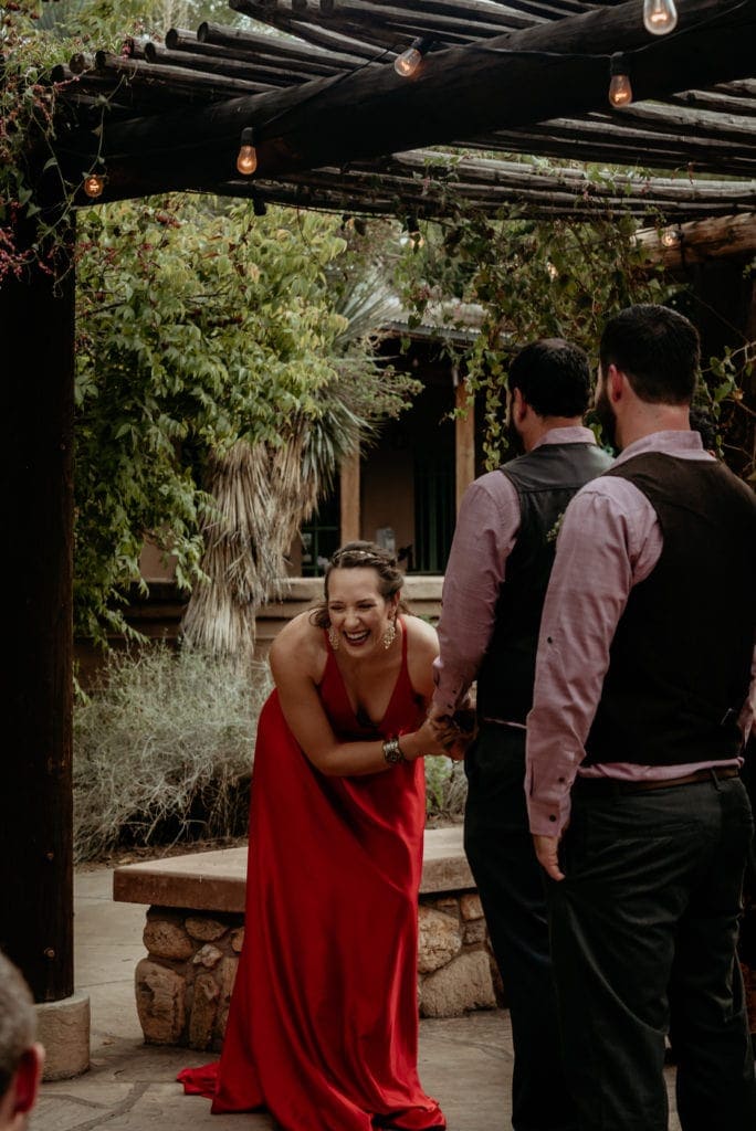 Bride laughing in her vibrant red wedding dress