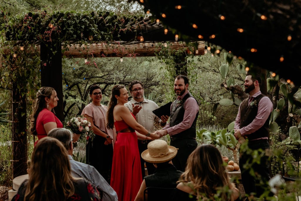 Vines and trees with lights surround happy wedding couple during their Tucson Intimate Wedding