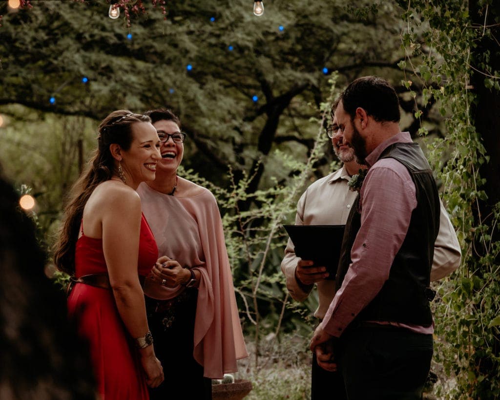 Non-traditional wedding couple in red dress and leather vest at Tucson Botanical Gardens wedding
