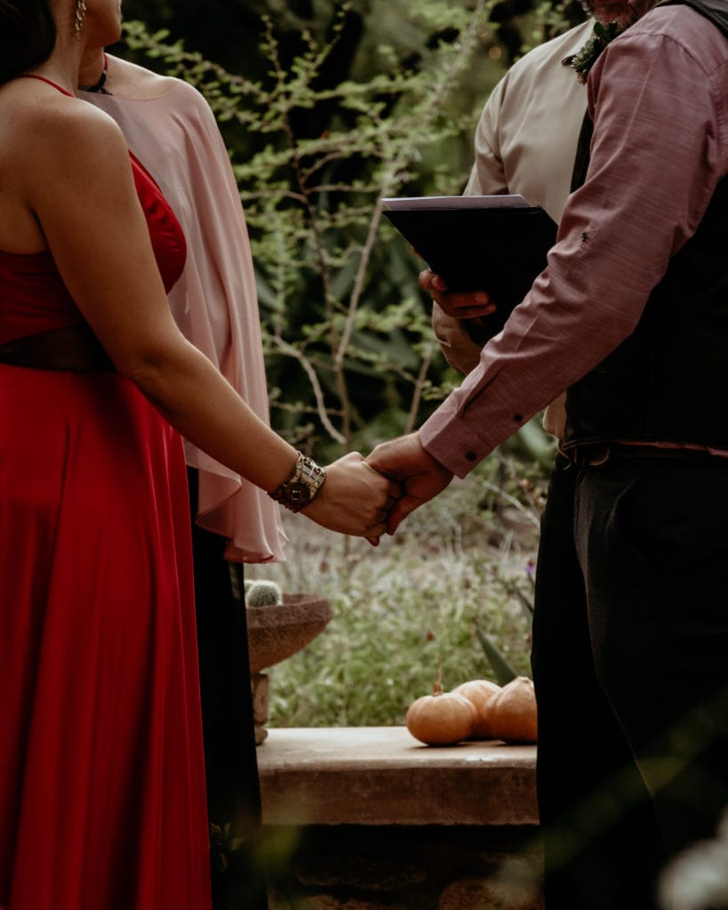 Bride and groom holding hands during their Tucson Botanical Garden Ceremony