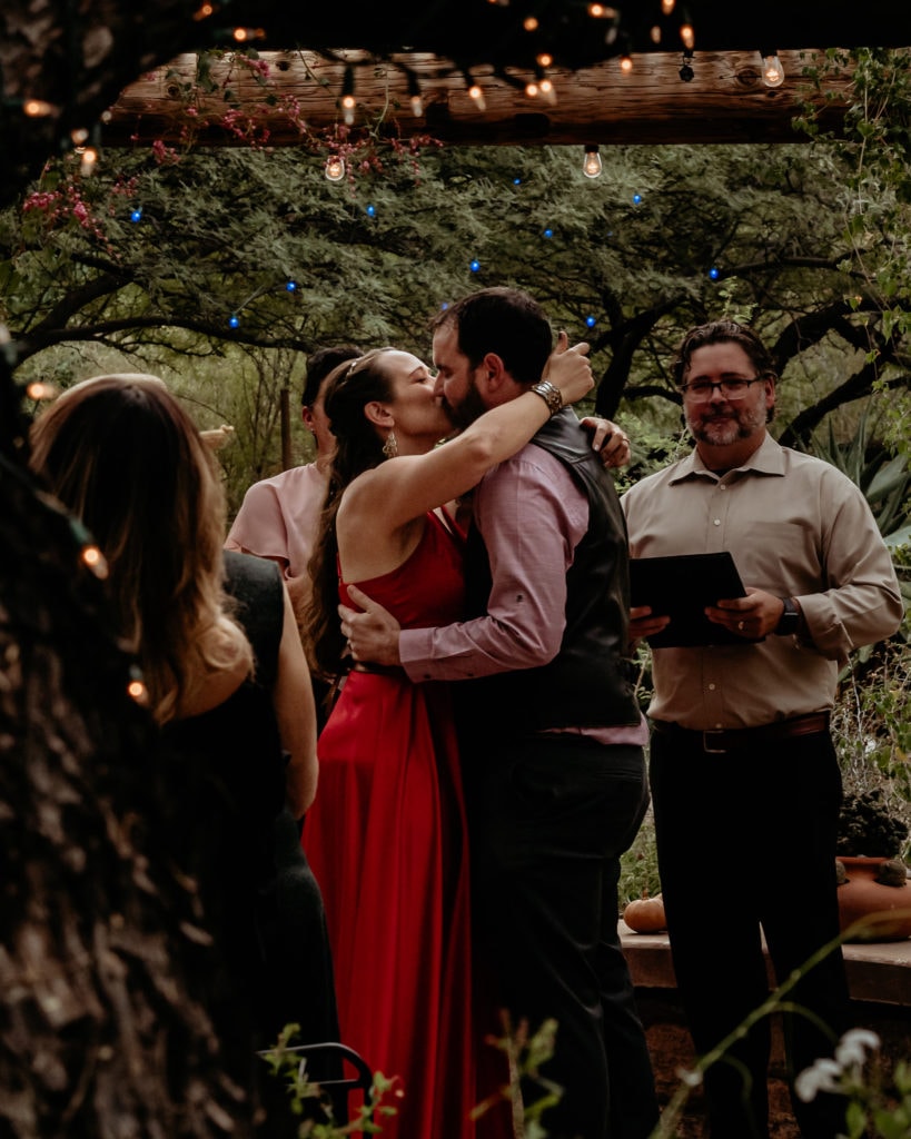 Sealed with a kiss- bride and groom kiss in the Porter Hall and Reception Garden at the Tucson Botanical Gardens