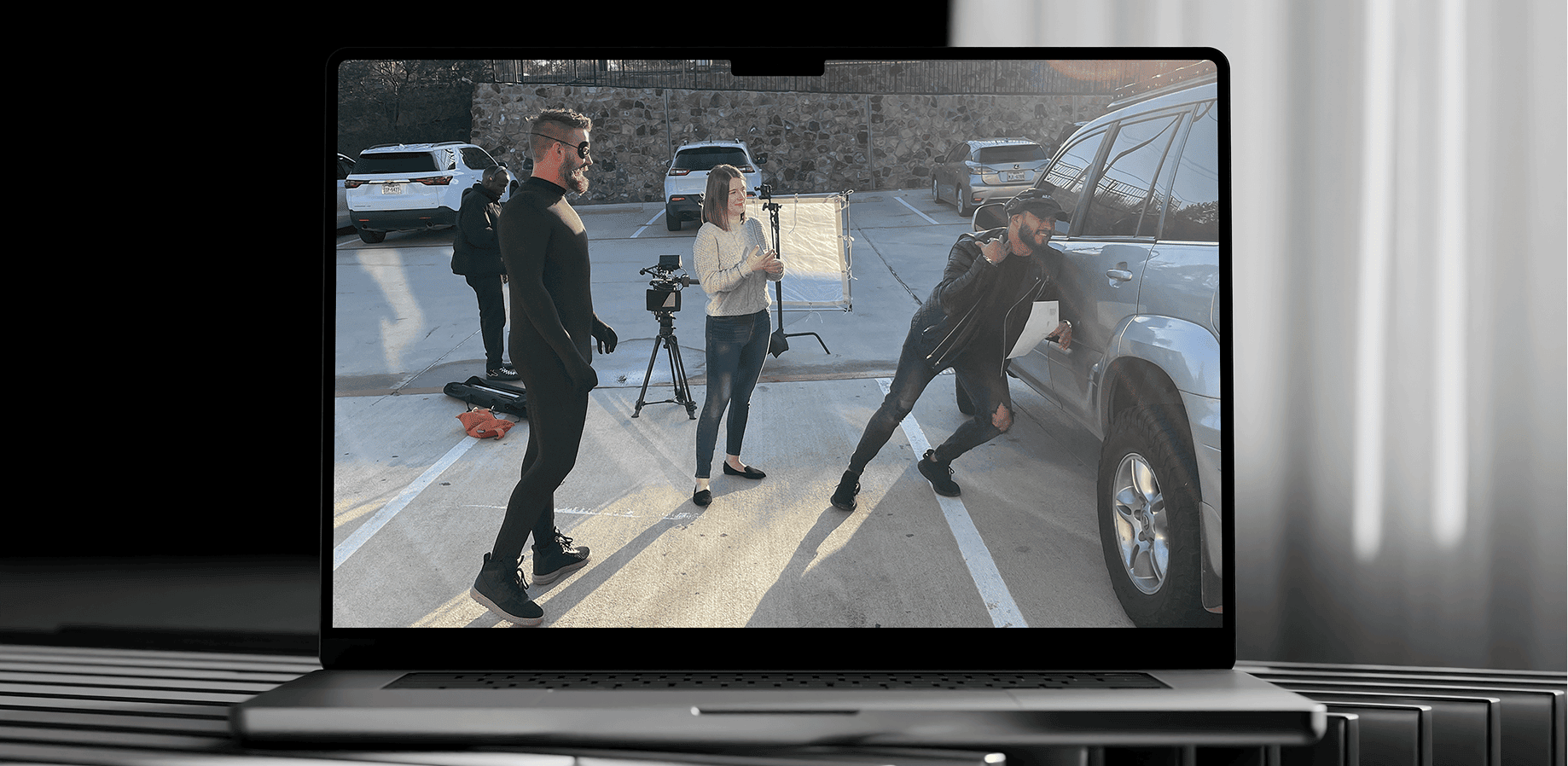 Video production team filming content on laptop screen, TeamForce Solutions creative services.