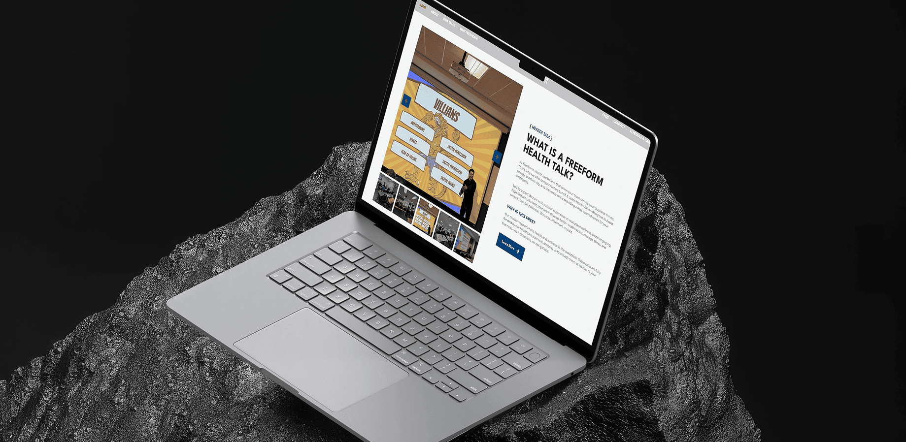 Laptop displaying TeamForce Solutions website on a dark surface.