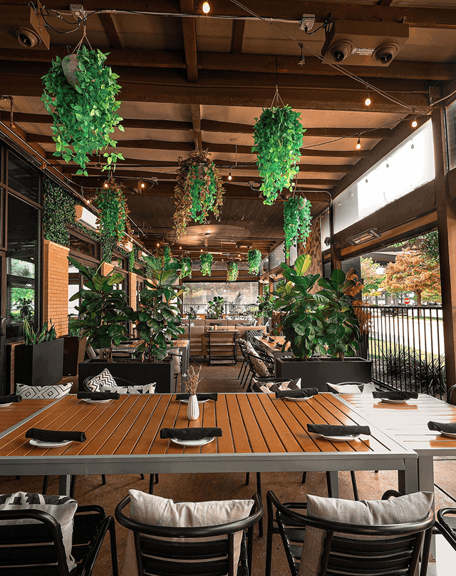 Bavette Grill patio with lush greenery and upscale dining ambiance.