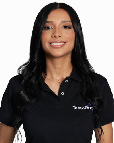 Professional woman in TeamForce Solutions uniform smiling at camera.