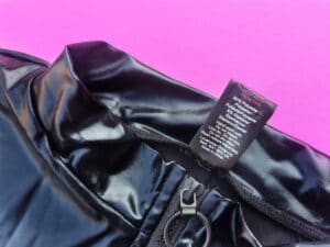 Je ziet de binnenkant van het labeltje van de lovehoney fierce wet look body, waar onder andere staat dat het materiaal brandgevaarlijk is.