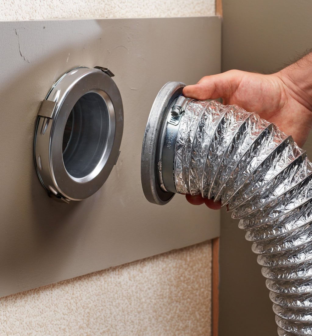 Gas dryer vented with rigid metal duct through an exterior wall.