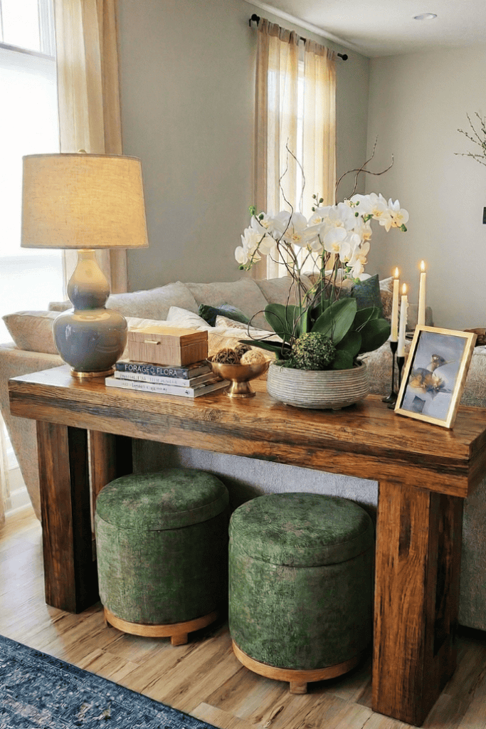 Elegant living room console table with floral decor, candles, and cozy seating area. Perfect for sty.