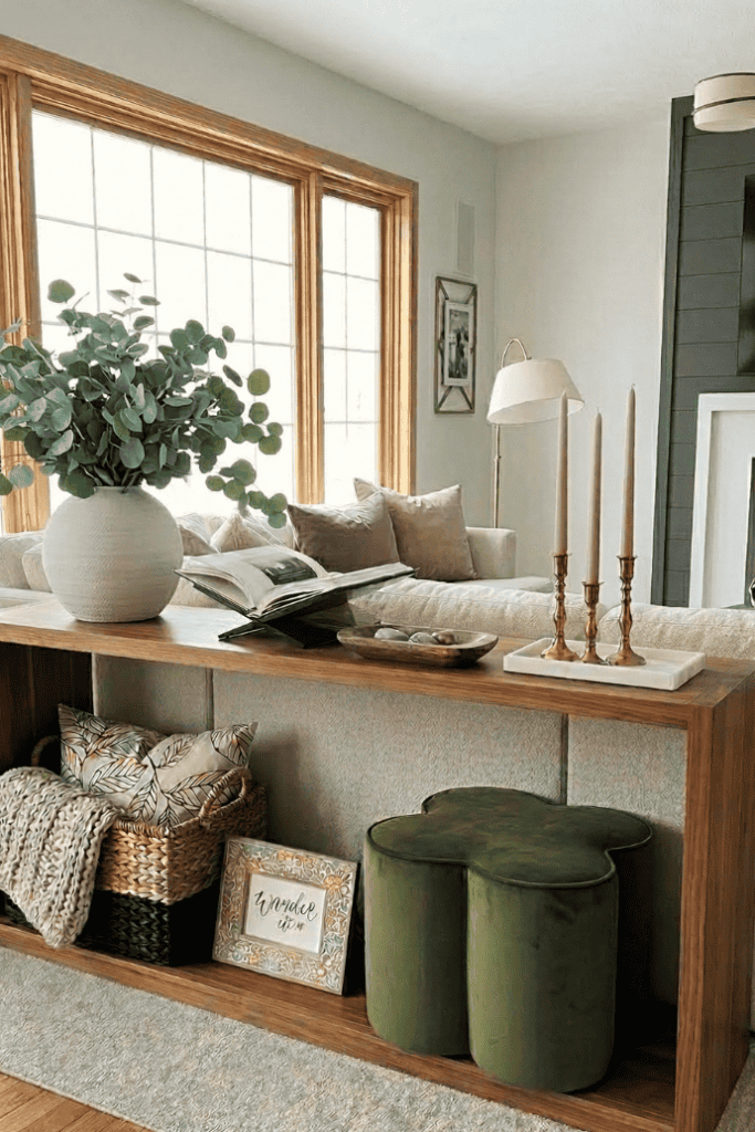 Elegant living room console table with decorative items and cozy seating area.
