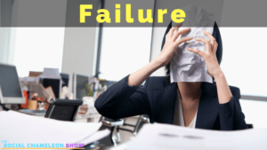 A frustrated woman in a business suit covers her face with a crumpled paper with the word "Failure" displayed in large letters overhead, amidst a cluttered office desk.