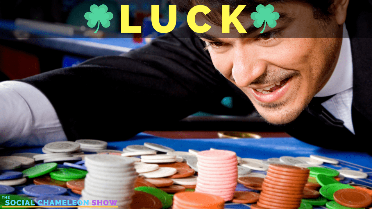 A man exuberantly playing at a colorful casino table, surrounded by stacks of chips, with the word "luck" prominently displayed above him.