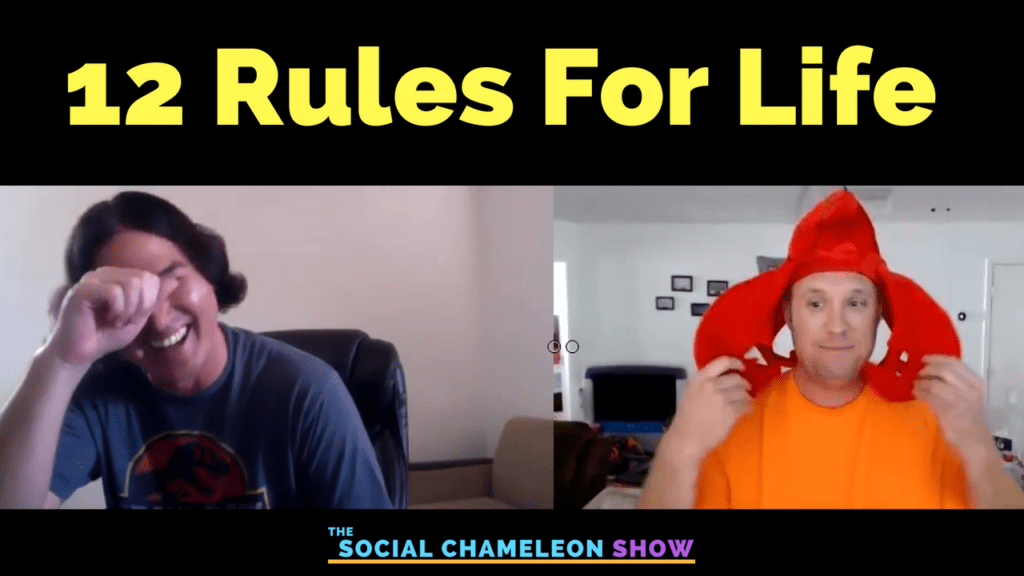 Two men in a video podcast; one smiling and wiping his eye, wearing a casual shirt, and the other wearing a bright orange squid hat, adjusting it with an amused expression. text reads "12 rules for life - the social chameleon show.