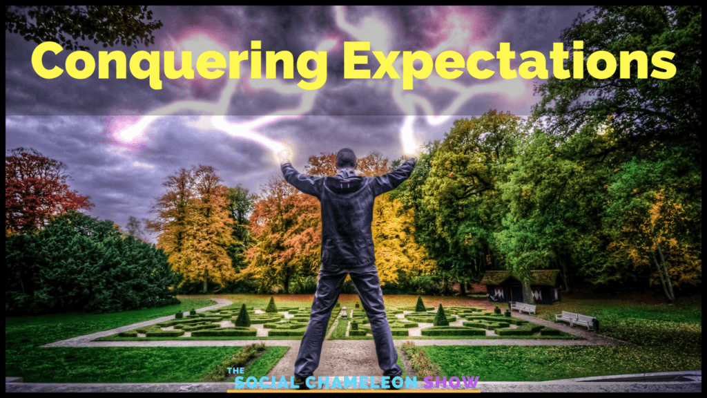 A man stands triumphantly with arms raised in a vibrant park, facing a stormy sky with dramatic lightning. text on the image reads "conquering expectations - the social chameleon show.