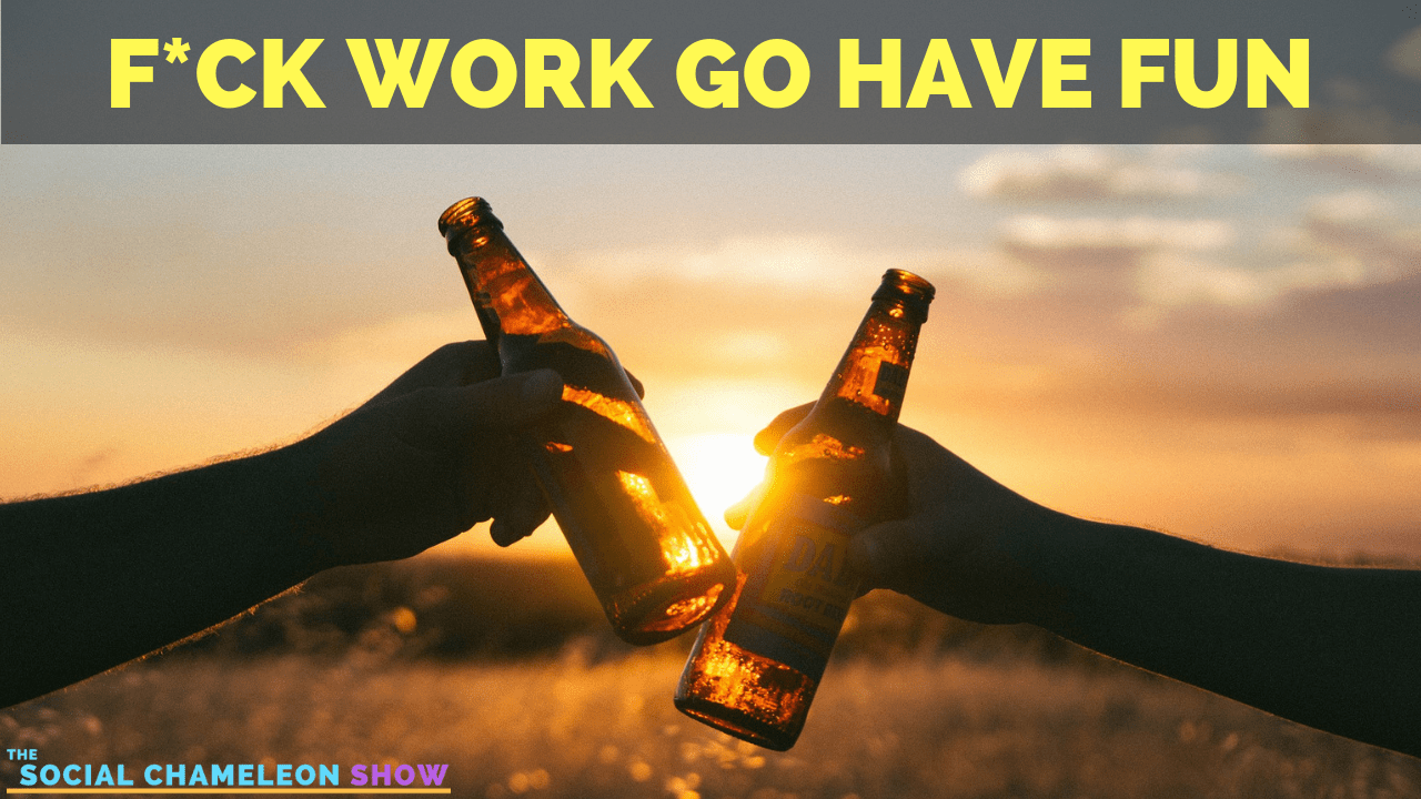Two people clinking beer bottles at sunset with text overlay "FUCK WORK GO HAVE FUN - the social chameleon show".