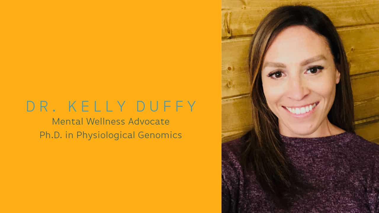 Portrait of a smiling person with long brown hair, wearing a dark sweater, against a wooden wall. To the left, text reads: "Dr. Kelly Duffy, Mental Wellness Advocate," with a Ph.D. in Physiological Genomics on a yellow background.
