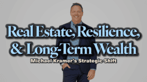 Real Estate Resilience and Long-Term Wealth: Michael Kramer's Strategic Shift. A man in a suit, Michael Kramer, smiles at the camera. The text overlaid reads "Real Estate, Resilience, & Long-Term Wealth: Michael Kramer's Strategic Shift." In the background, a light gray hue complements Michael Kramer's confident demeanor.