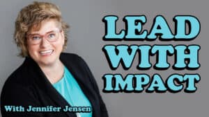 A smiling Jennifer Jensen with short curly hair and glasses wears a turquoise top and black blazer. Text reads: “LEAD WITH IMPACT” and “With Jennifer Jensen” on a gray background.