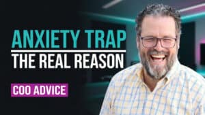 A smiling man with glasses stands in front of a blurred office background. Text reads, “ANXIETY TRAP THE REAL REASON” and “COO ADVICE.” This image highlights the journey of self mastery, offering insights into personal transformation for those seeking real change.