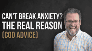 Michael Wood a smiling man with glasses and a beard stands next to the text: "Can't break anxiety? The real reason (COO advice)" on a dark background.
