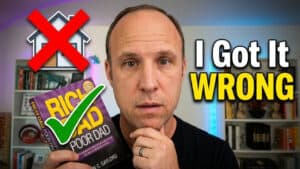 A man holds a “Rich Dad Poor Dad” book with a green checkmark, looking concerned. Behind him, a house icon with a red X and text says, “I Got It WRONG.” Shelves with books are in the background, suggesting he may have misunderstood the difference between liabilities and passive income as explained in “Rich Dad Poor Dad.”.