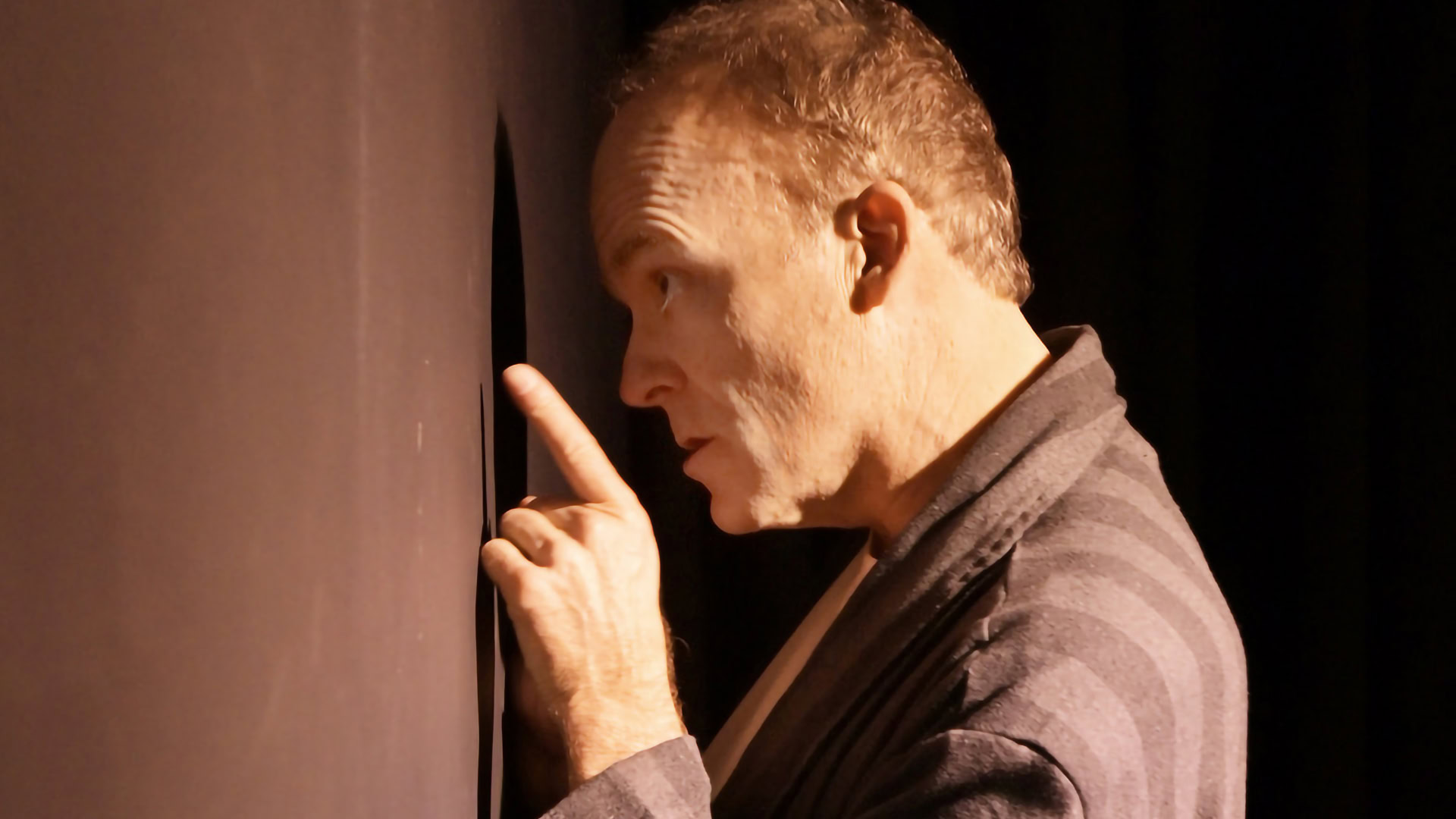 A performer from The StageCrafts passionately delivering a monologue on stage, emphasizing expressive gestures and intense focus.