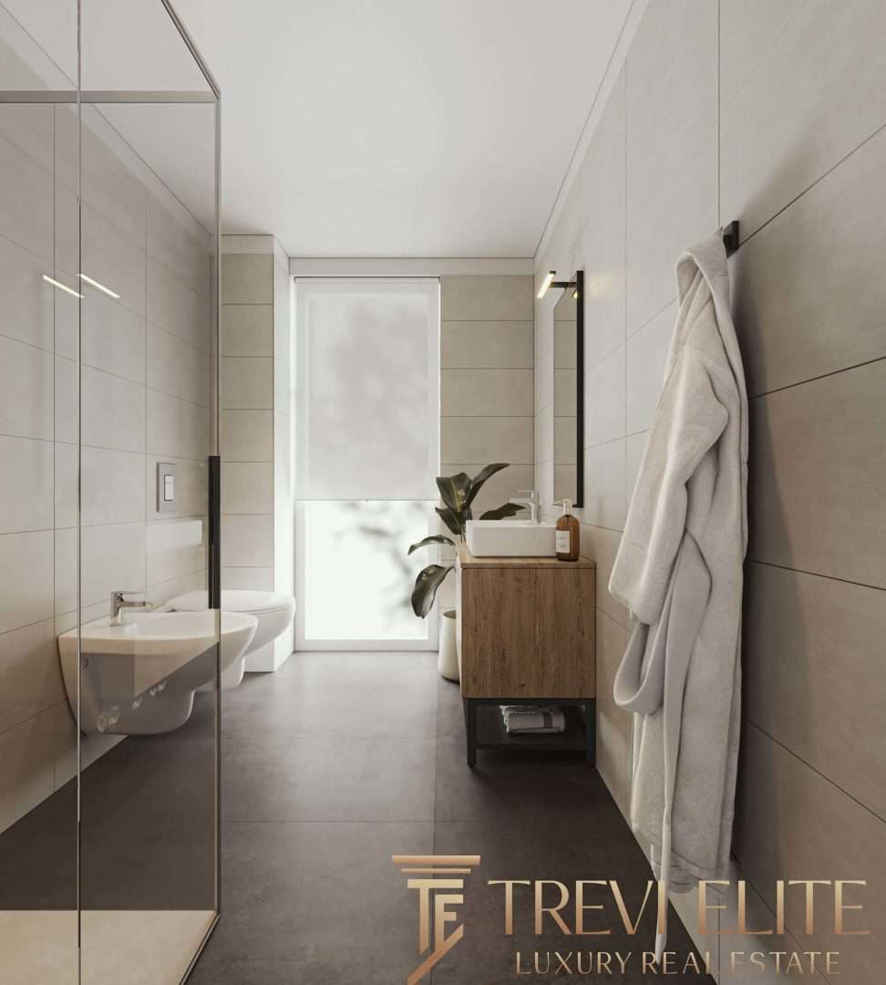 Элегантная современная ванная комната с минималистским дизайном, светлыми оттенками и стильными элементами интерьера, созданная для роскошных итальянских и международных объектов недвижимости Треви Элит.