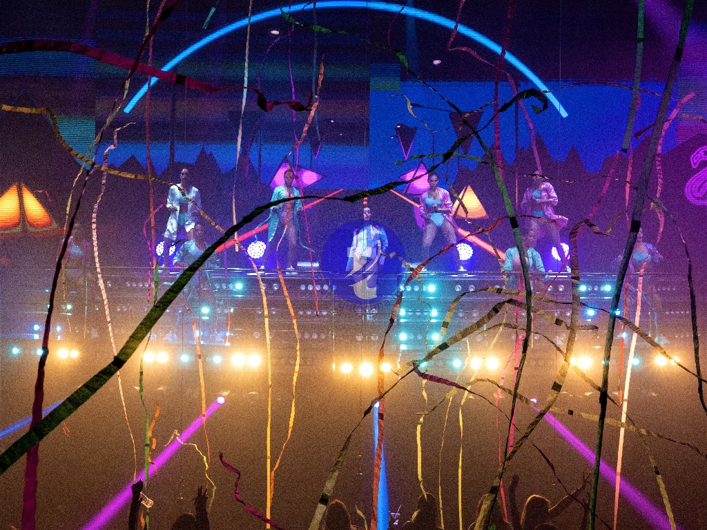 Punta Cana Colorful night scene with performers and neon lights in Punta Cana entertainment venue.