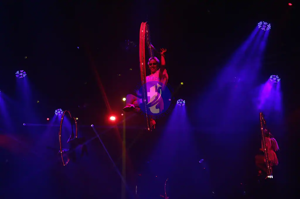 Punta Cana Aerialist performing on a hoop during a vibrant night show in Punta Cana.