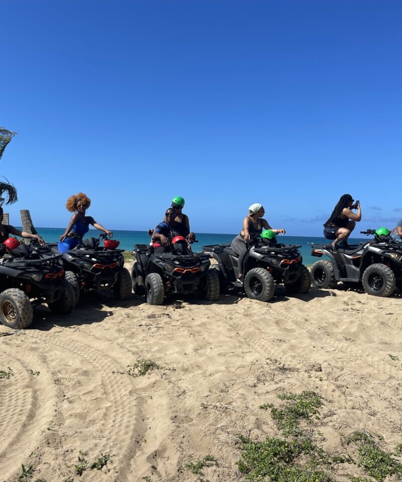Punta Cana ATV adventure tour in Punta Cana with a group riding quad bikes along the beach.