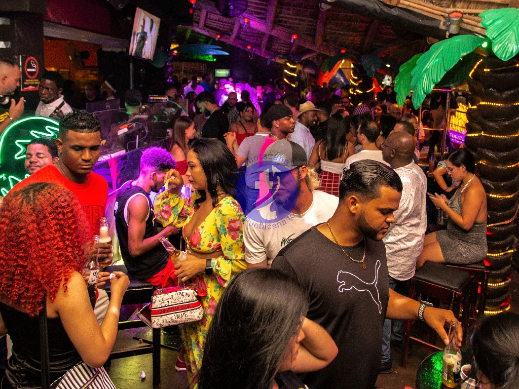 Punta Cana Crowded bar scene in Punta Cana with energetic party atmosphere and diverse guests.