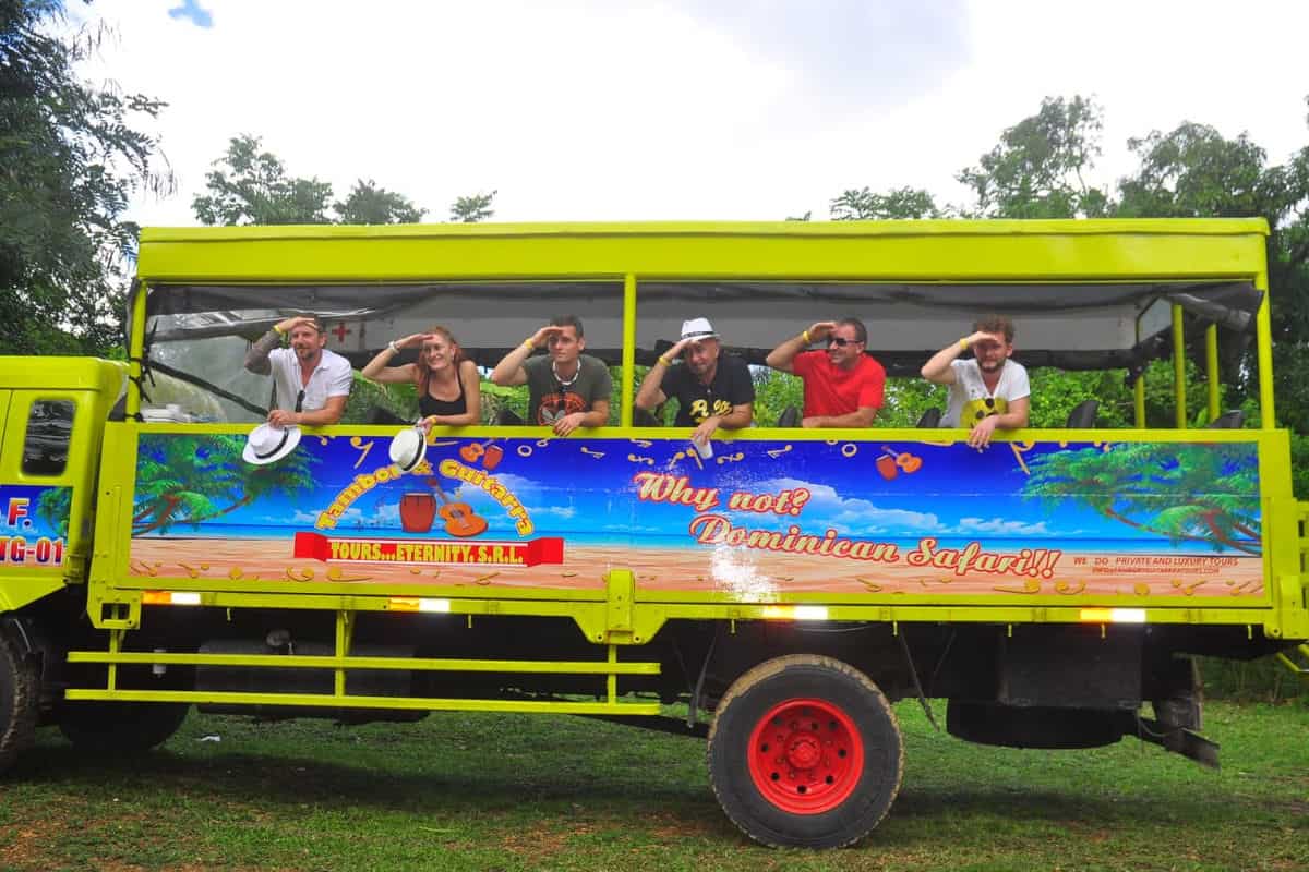 Punta Cana Tourists enjoying a lively Punta Cana sightseeing tour on a bright yellow bus.