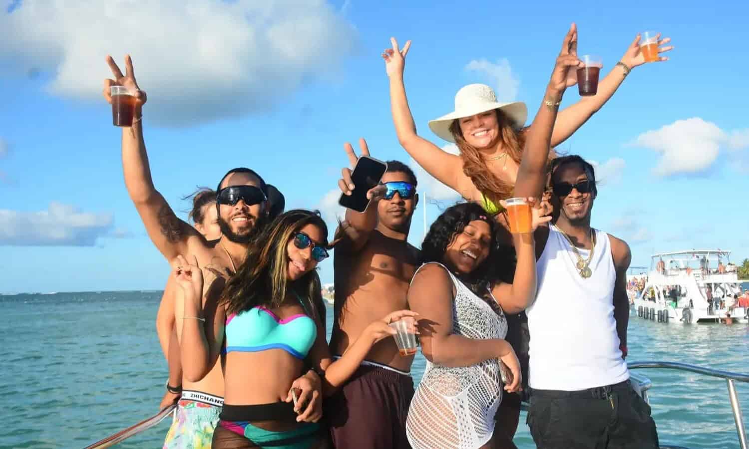 Punta Cana Group of friends celebrating on a boat with drinks in Punta Cana, Dominican Republic.