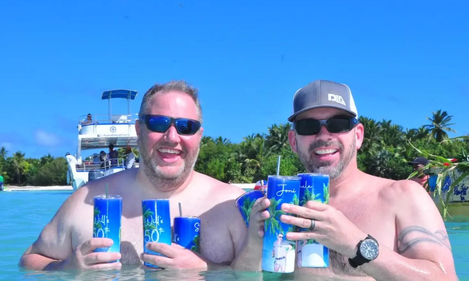 Punta Cana Two men enjoying drinks on a catamaran during a Punta Cana party boat tour.