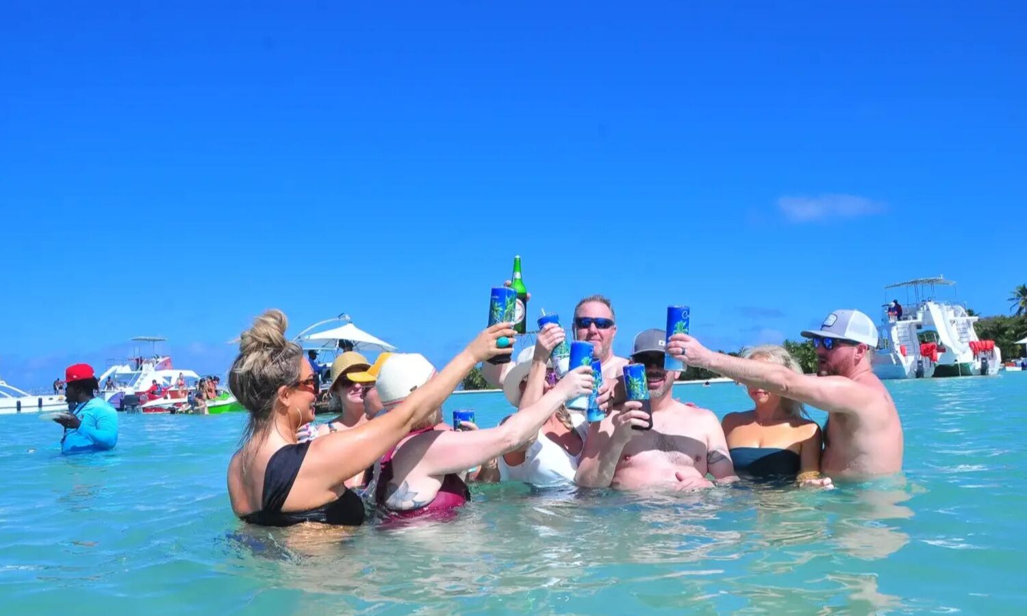 Punta Cana Group of friends raising drinks during a boat party in Punta Cana, Dominican Republic.