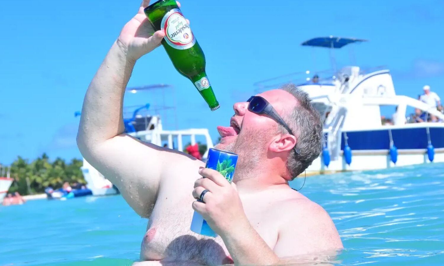 Punta Cana Man enjoying a cold beer on a boat during a Punta Cana excursion.