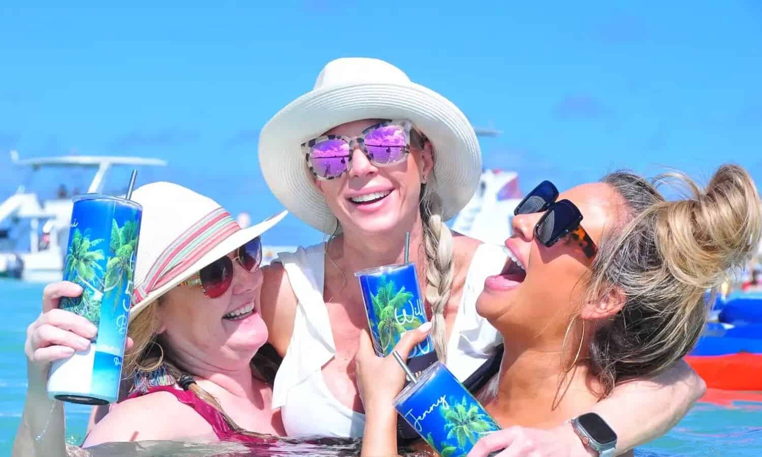 Punta Cana Women with hats and sunglasses having fun on a boat in Punta Cana.