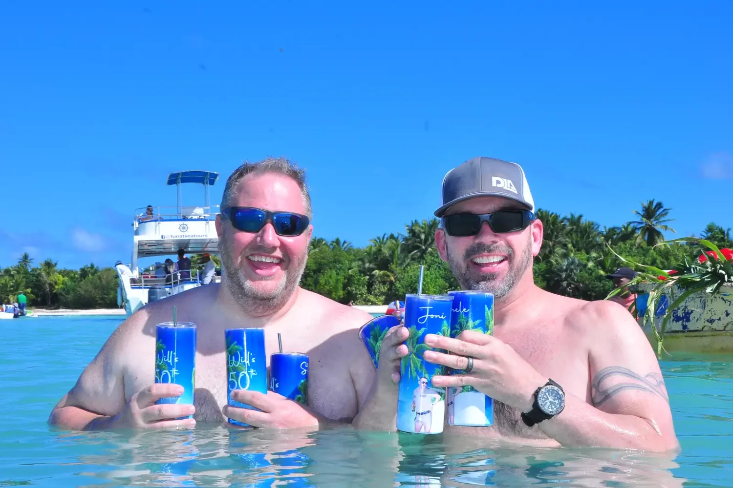 Punta Cana Two men enjoying drinks in the water during a Punta Cana excursion.
