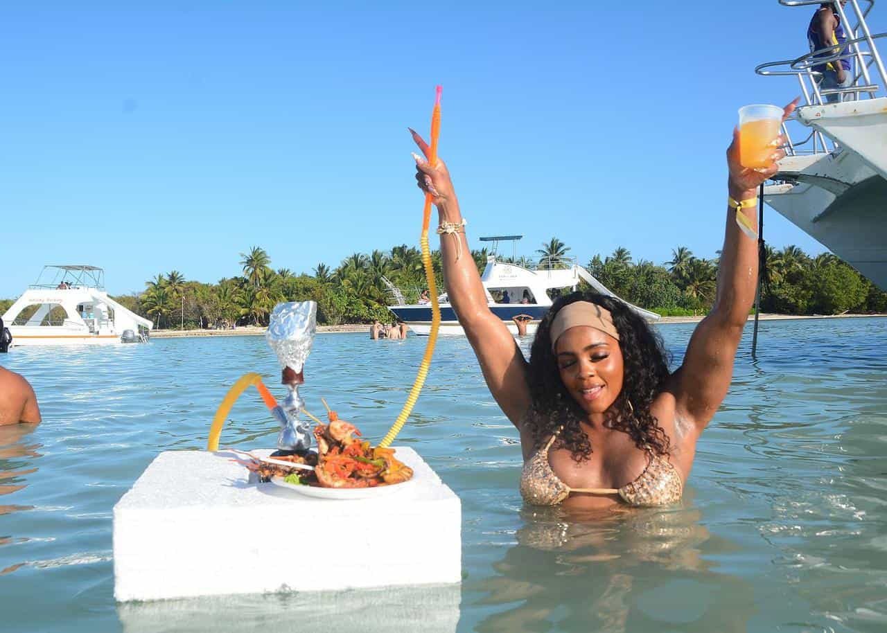 Punta Cana Woman enjoying a boat party with seafood and drinks in Punta Cana, Dominican Republic.