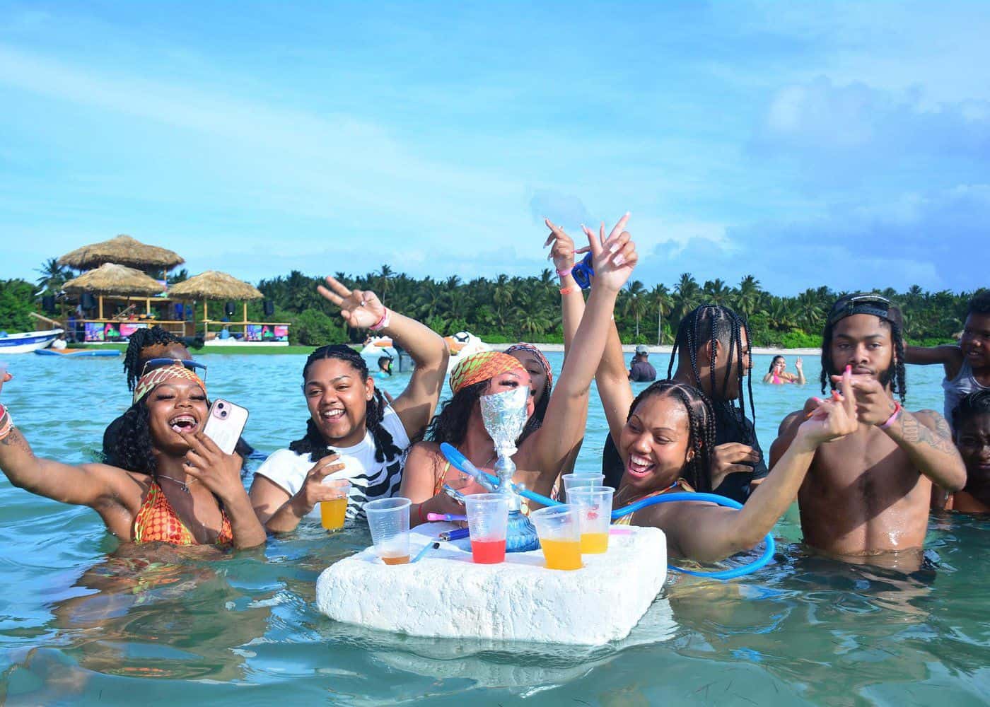 Punta Cana Friends having fun with drinks on a floating tray in Punta Cana's clear waters.