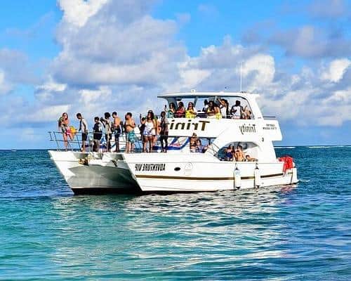 Punta Cana Group of tourists enjoying a catamaran party boat tour in the Caribbean waters near Punta Cana.