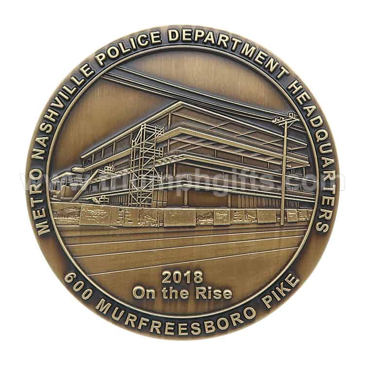 Metro Nashville Police Department headquarter construction medal with engraved building and text.